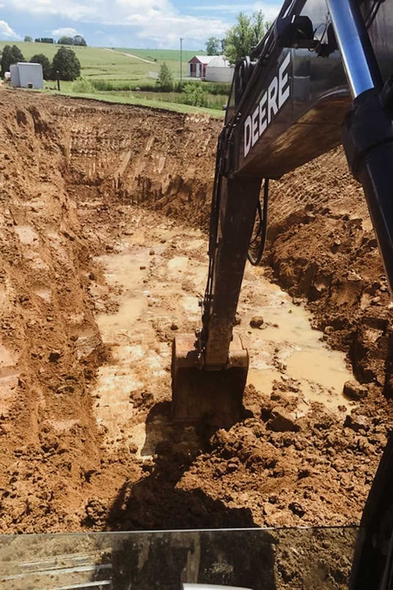 Excavator digging out mud