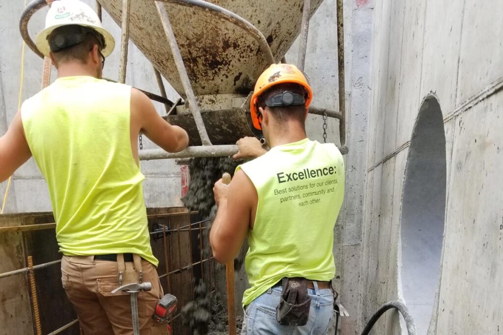 2 Staab employees pouring concrete