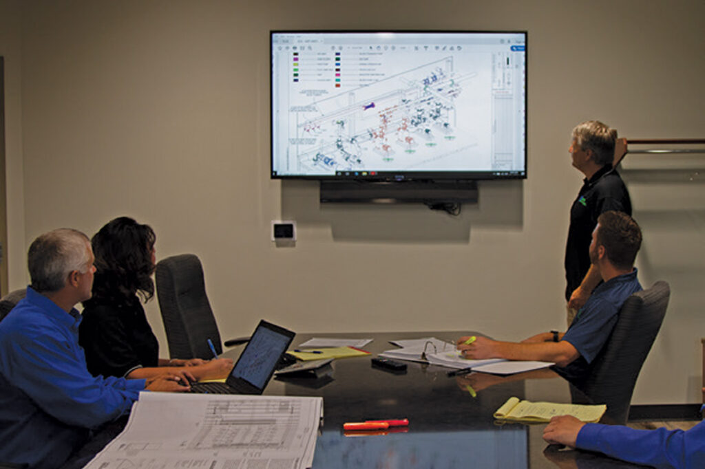 staabco employees looking at a 3d model on a screen