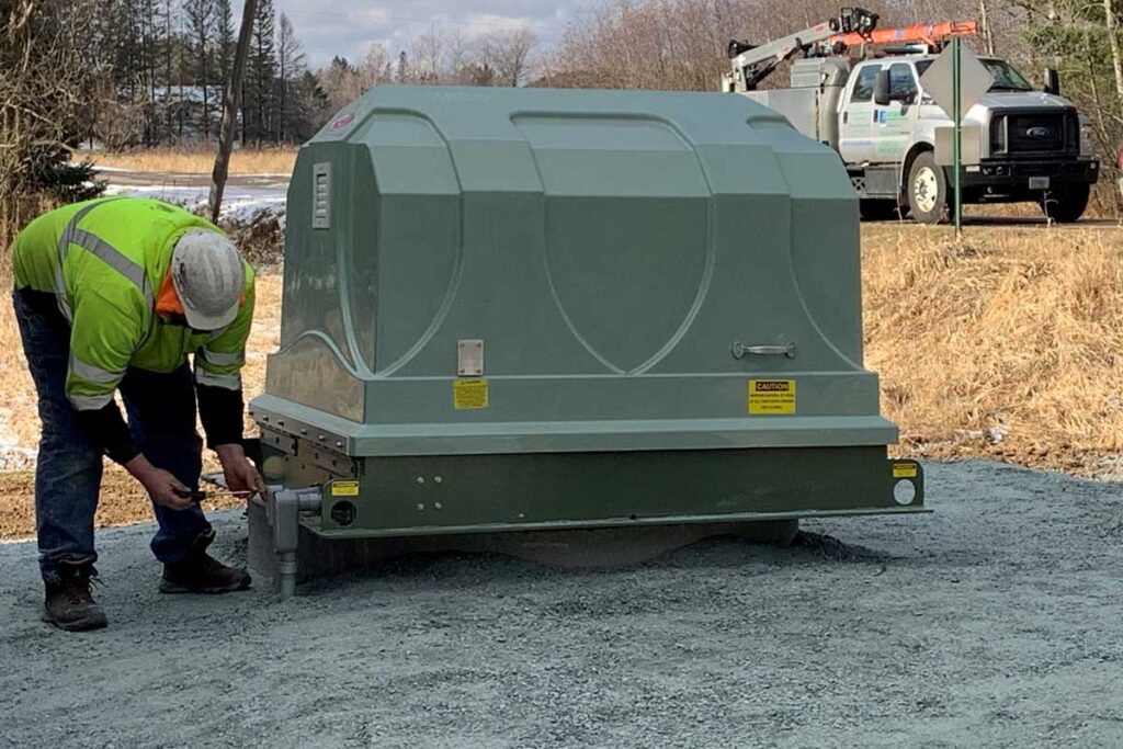 worker installing machine at jobsite