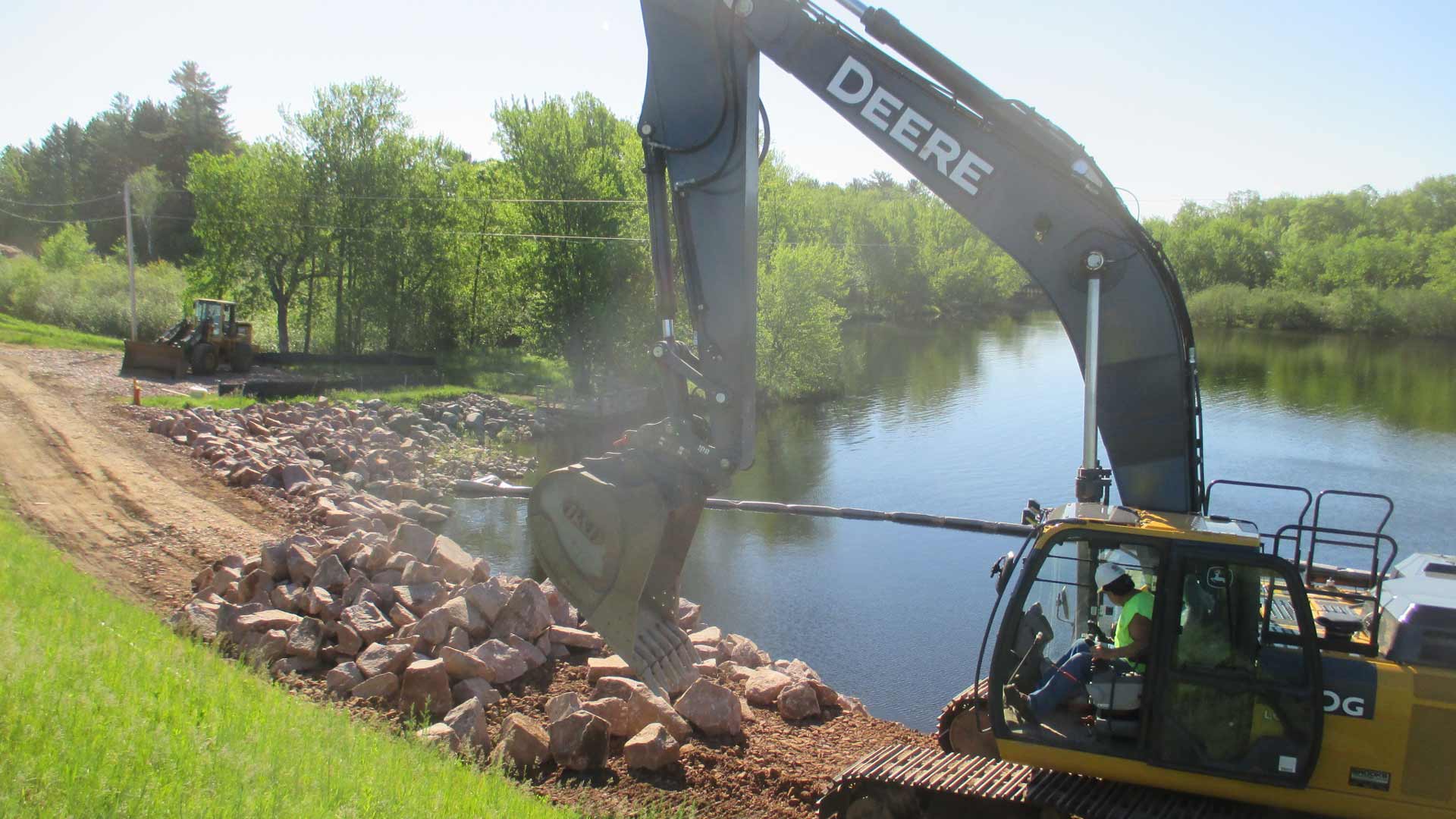 Excavator working by the water