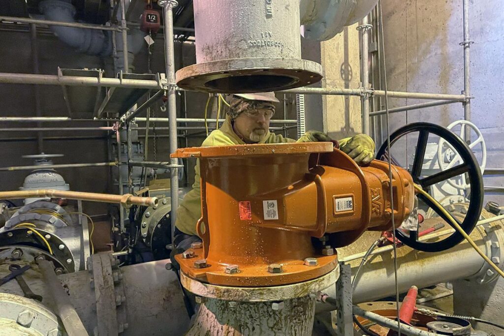 Staab employee working on a mechanical machine