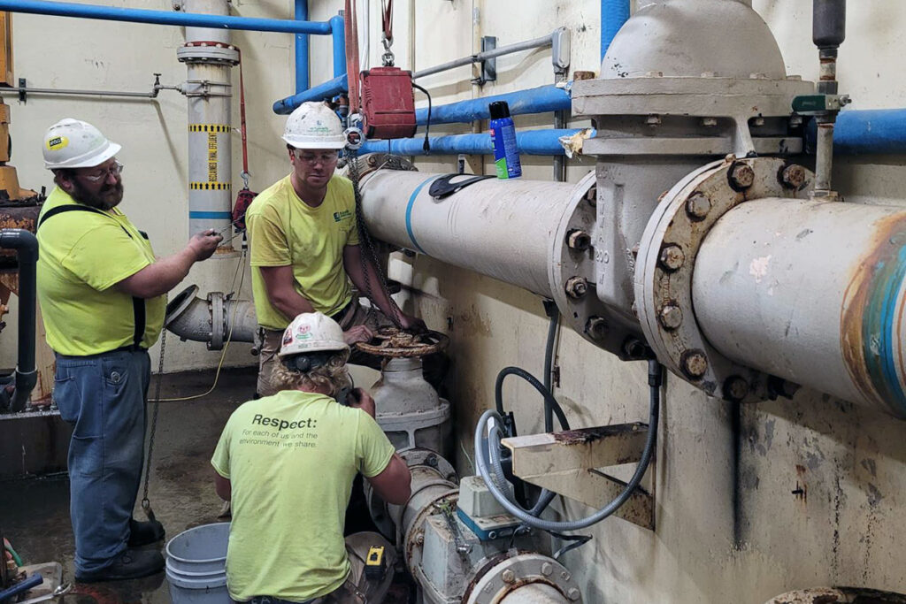 Staab employees working on a mechanical system