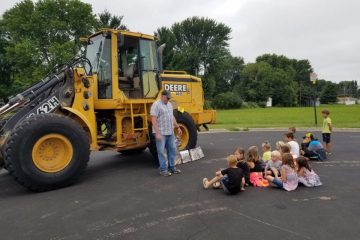 a staab employee talking to a group of kids